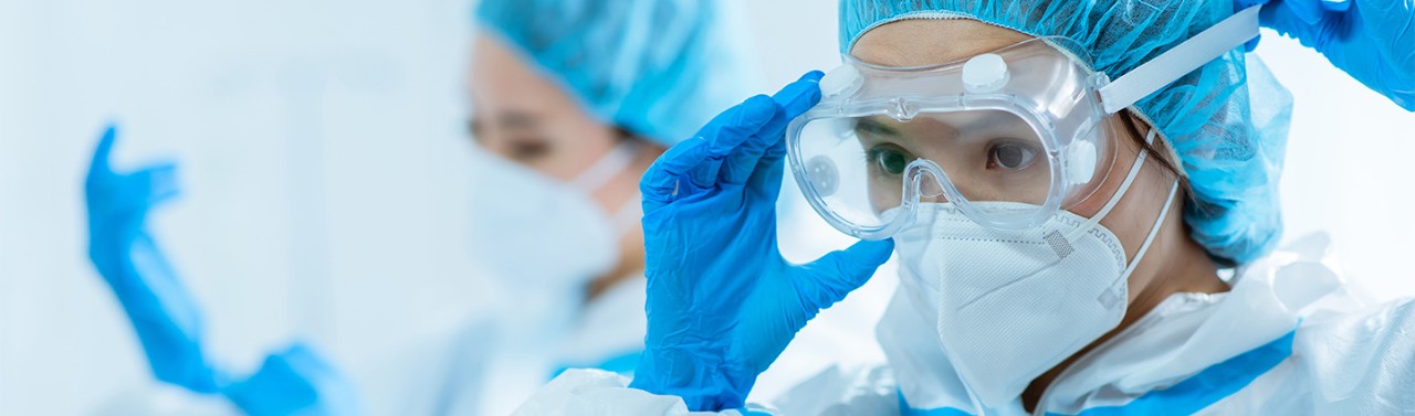 female medical worker wear protective suits and ready to take care of coronavirus patient in isolation room